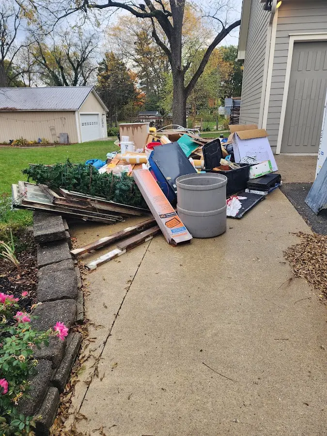 Dumpster being loaded with debris for Estate Cleanout Dumpster Rental in Pittsgrove